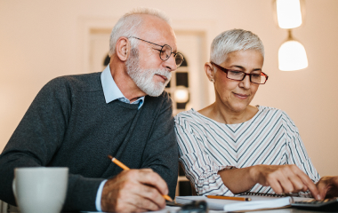 Older man and woman paying bills