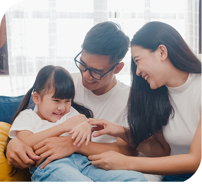A family laughing together on a couch